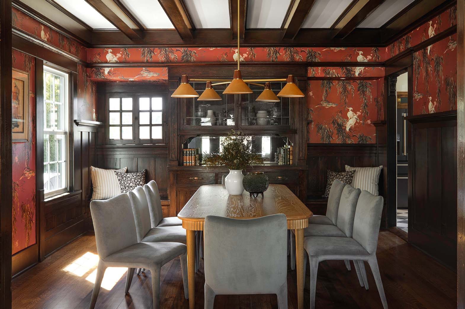 The dining room with willow wallpaper and a built-in hutch