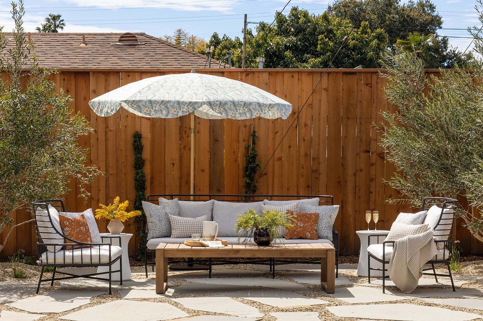 An outdoor lounge beneath a parasol on the garden patio