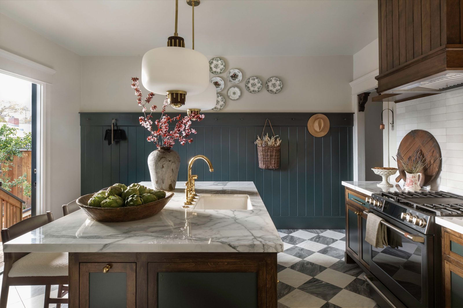 The kitchen with a marble island and checkerboard floor