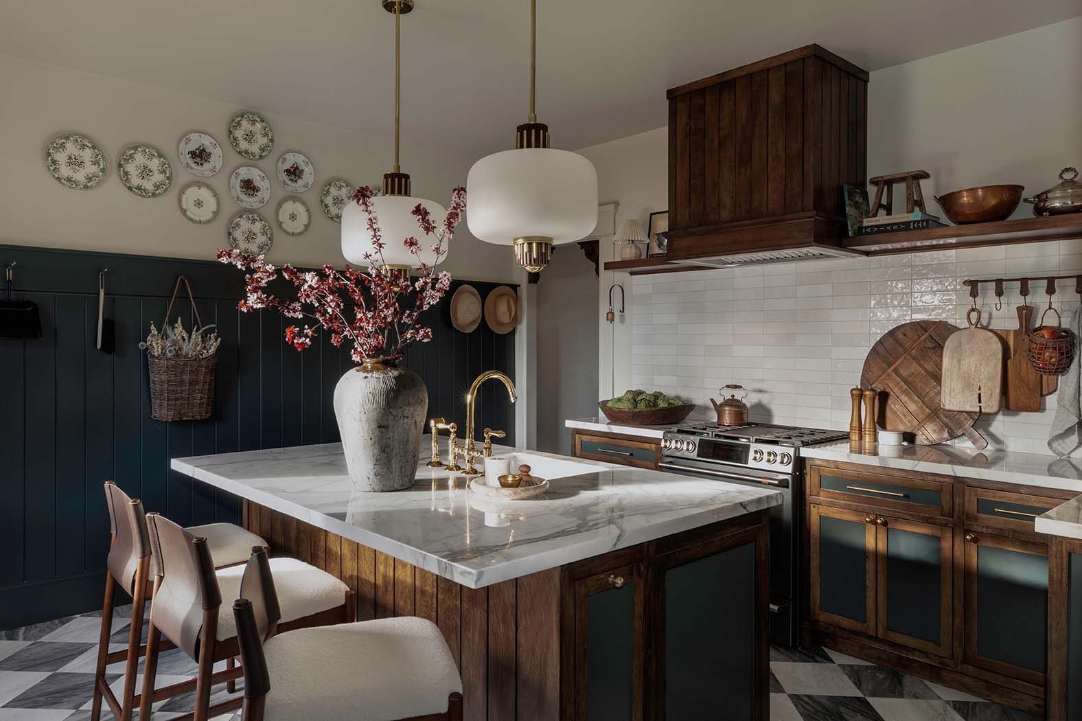 The kitchen with island seating and a wall of plates